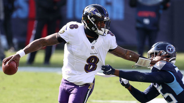NASHVILLE, TENNESSEE - JANUARY 10: Quarterback Lamar Jackson #8 of the Baltimore Ravens attempts to break a tackle from cornerback Adoree' Jackson #25 of the Tennessee Titans during the first half of their AFC Wild Card Playoff game at Nissan Stadium on January 10, 2021 in Nashville, Tennessee.