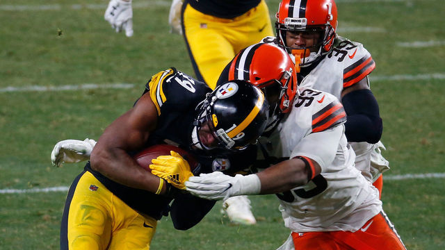 PITTSBURGH, PENNSYLVANIA - JANUARY 10: JuJu Smith-Schuster #19 of the Pittsburgh Steelers is brought down by B.J. Goodson #93 of the Cleveland Browns during the second half of the AFC Wild Card Playoff game at Heinz Field on January 10, 2021 in Pittsburgh, Pennsylvania.