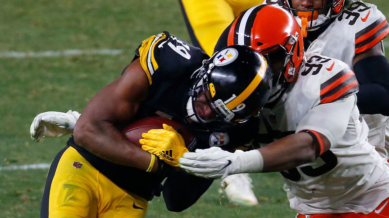 PITTSBURGH, PENNSYLVANIA - JANUARY 10: JuJu Smith-Schuster #19 of the Pittsburgh Steelers is brought down by B.J. Goodson #93 of the Cleveland Browns during the second half of the AFC Wild Card Playoff game at Heinz Field on January 10, 2021 in Pittsburgh, Pennsylvania.