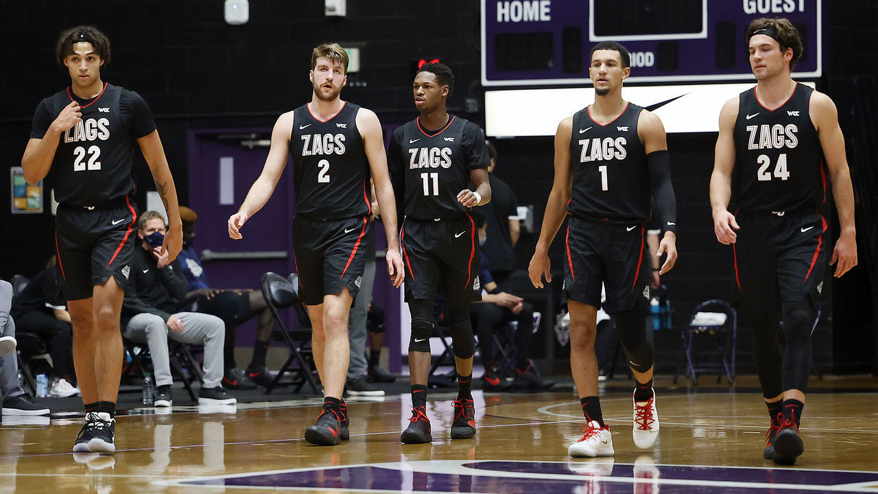 PORTLAND, OREGON - JANUARY 09: Anton Watson #22, Drew Timme #2, Joel Ayayi #11, Jalen Suggs #1, Corey Kispert #24 of the Gonzaga Bulldogs walk back to the court after a timeout during the first half against the Portland Pilots at Chiles Center on January 09, 2021 in Portland, Oregon.