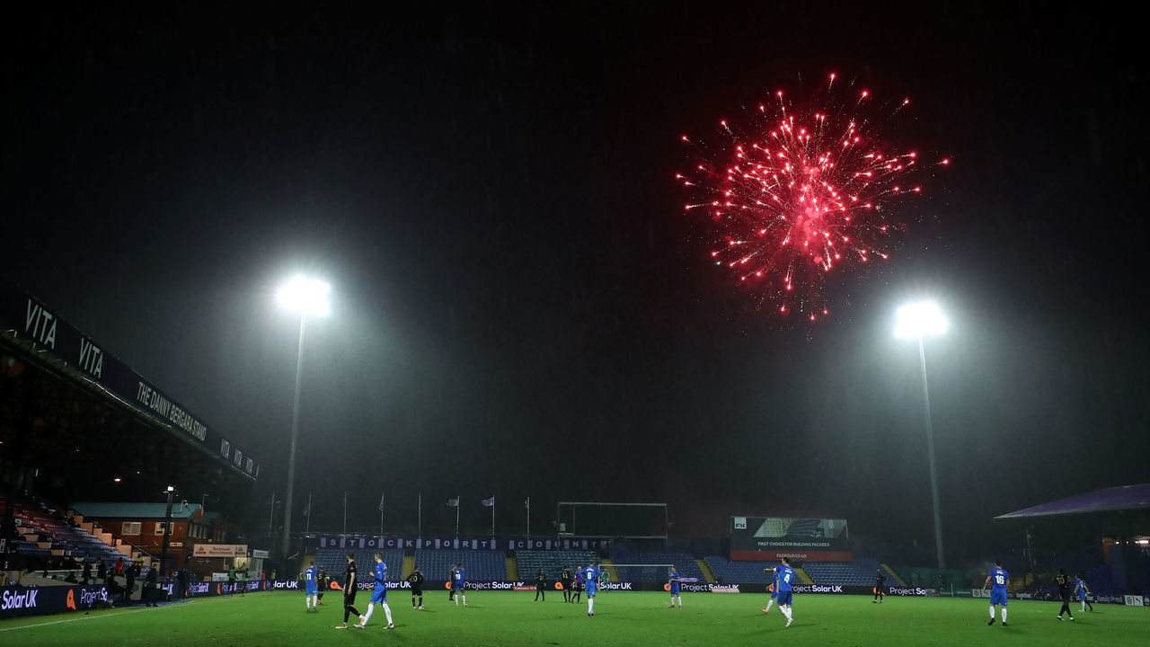 The referee pauses the game as fireworks are set off near the ground during the Emirates FA Cup third round match at Edgeley Park, Stockport.