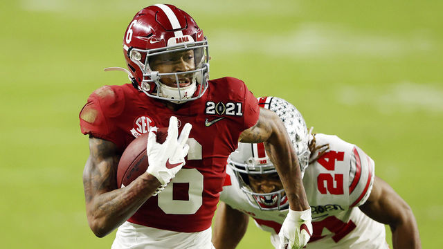 MIAMI GARDENS, FLORIDA - JANUARY 11: DeVonta Smith #6 of the Alabama Crimson Tide rushes ahead of Josh Proctor #41 of the Ohio State Buckeyes during the second quarter of the College Football Playoff National Championship game at Hard Rock Stadium on January 11, 2021 in Miami Gardens, Florida.