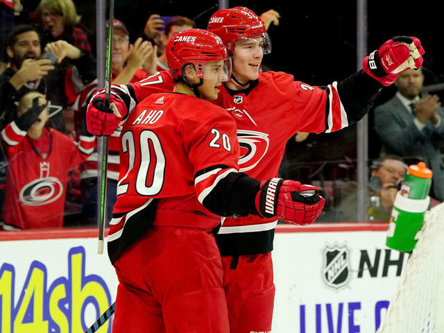 RALEIGH, NC - OCTOBER 26: Andrei Svechnikov #37 of the Carolina Hurricanes scores a goal and celebrates with teammate Sebastian Aho #20 an NHL game against the Chicago Blackhawks on October 26, 2019 at PNC Arena in Raleigh North Carolina.