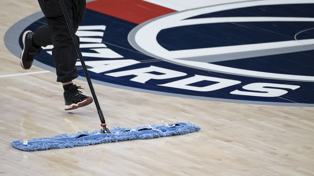 WASHINGTON, DC - JANUARY 09: A worker cleans the court before the game between the Washington Wizards and the Miami Heat at Capital One Arena on January 9, 2021 in Washington, DC.