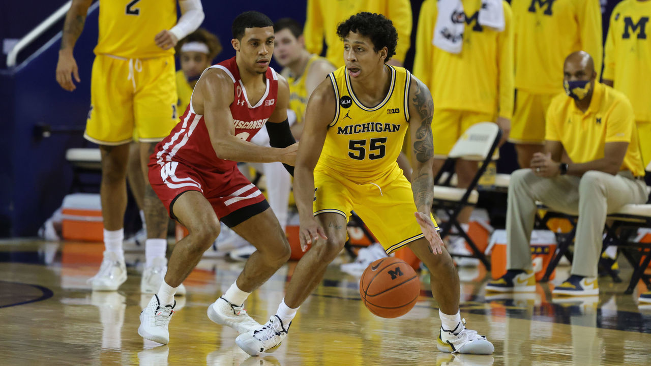 ANN ARBOR, MICHIGAN - JANUARY 12: Eli Brooks #55 of the Michigan Wolverines looks to drive the ball as D'Mitrik Trice #0 of the Wisconsin Badgers defends during the second half of the game at Crisler Arena on January 12, 2021 in Ann Arbor, Michigan. Michigan defeated Wisconsin 77-54.