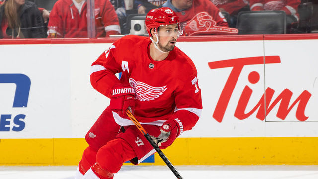 DETROIT, MI - MARCH 08: Dylan Larkin #71 of the Detroit Red Wings turns up ice with the puck against the Tampa Bay Lightning during an NHL game at Little Caesars Arena on March 8, 2020 in Detroit, Michigan. Detroit defeated Tampa Bay 5-4 in a shootout.