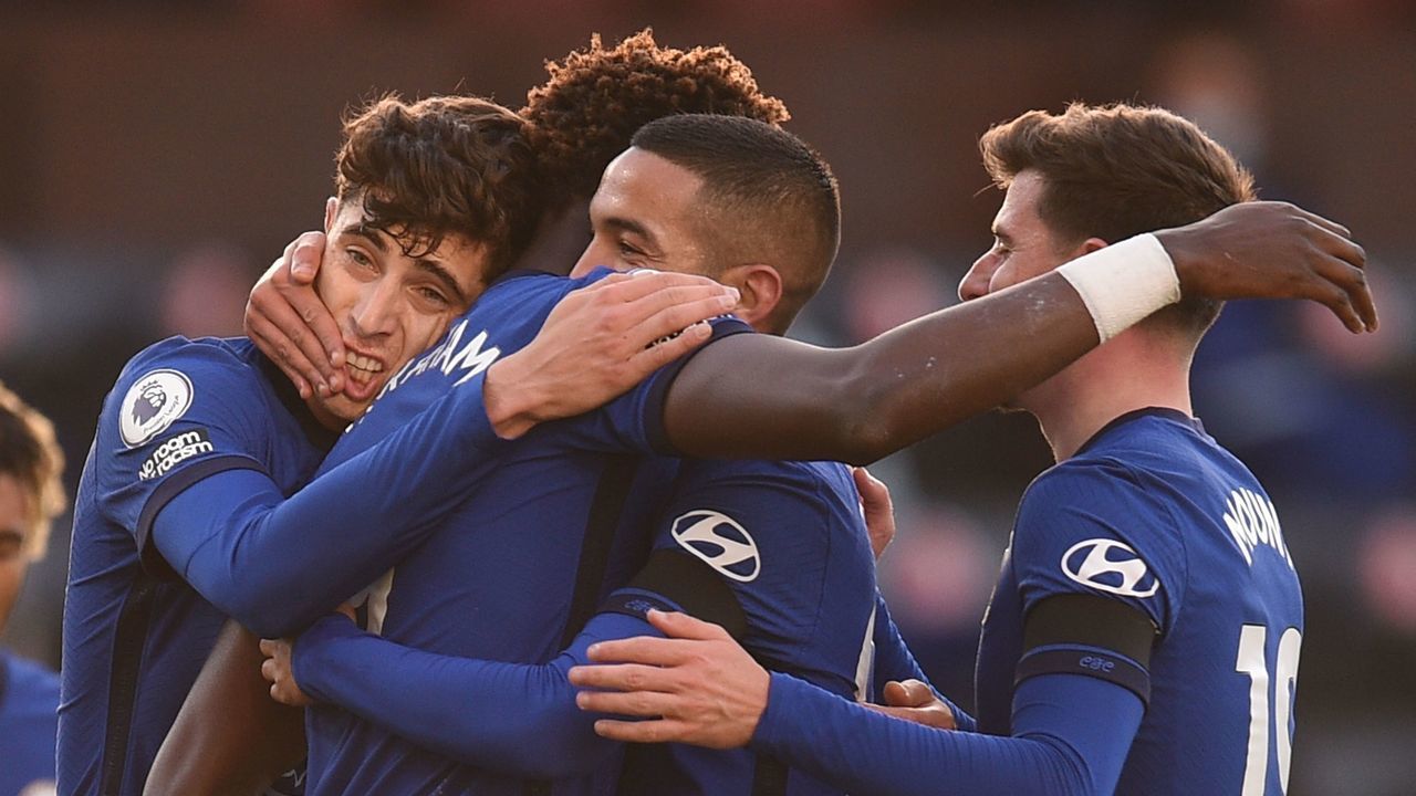 Chelsea's Moroccan midfielder Hakim Ziyech (2R) embraces team-mates after scoring the opening goal during the English Premier League football match between Burnley and Chelsea at Turf Moor in Burnley, north west England on October 31, 2020.