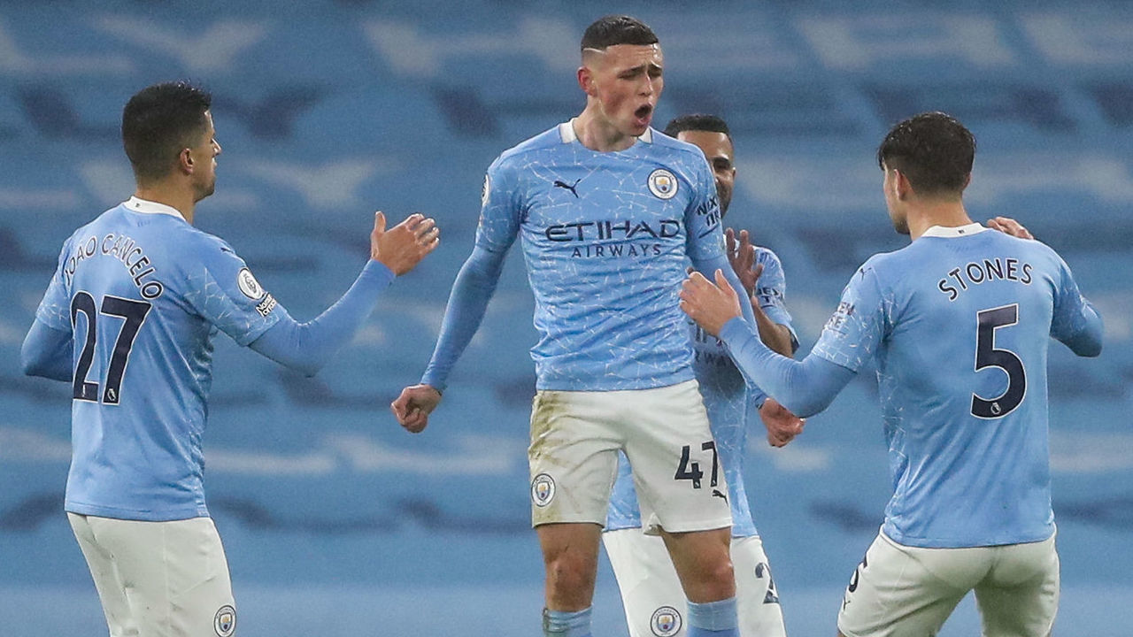 MANCHESTER, ENGLAND - JANUARY 13: Phil Foden of Manchester City celebrates after scoring a goal to make it 1-0 during the Premier League match between Manchester City and Brighton & Hove Albion at Etihad Stadium on January 13, 2021 in Manchester, United Kingdom. Sporting stadiums around England remain under strict restrictions due to the Coronavirus Pandemic as Government social distancing laws prohibit fans inside venues resulting in games being played behind closed doors.
