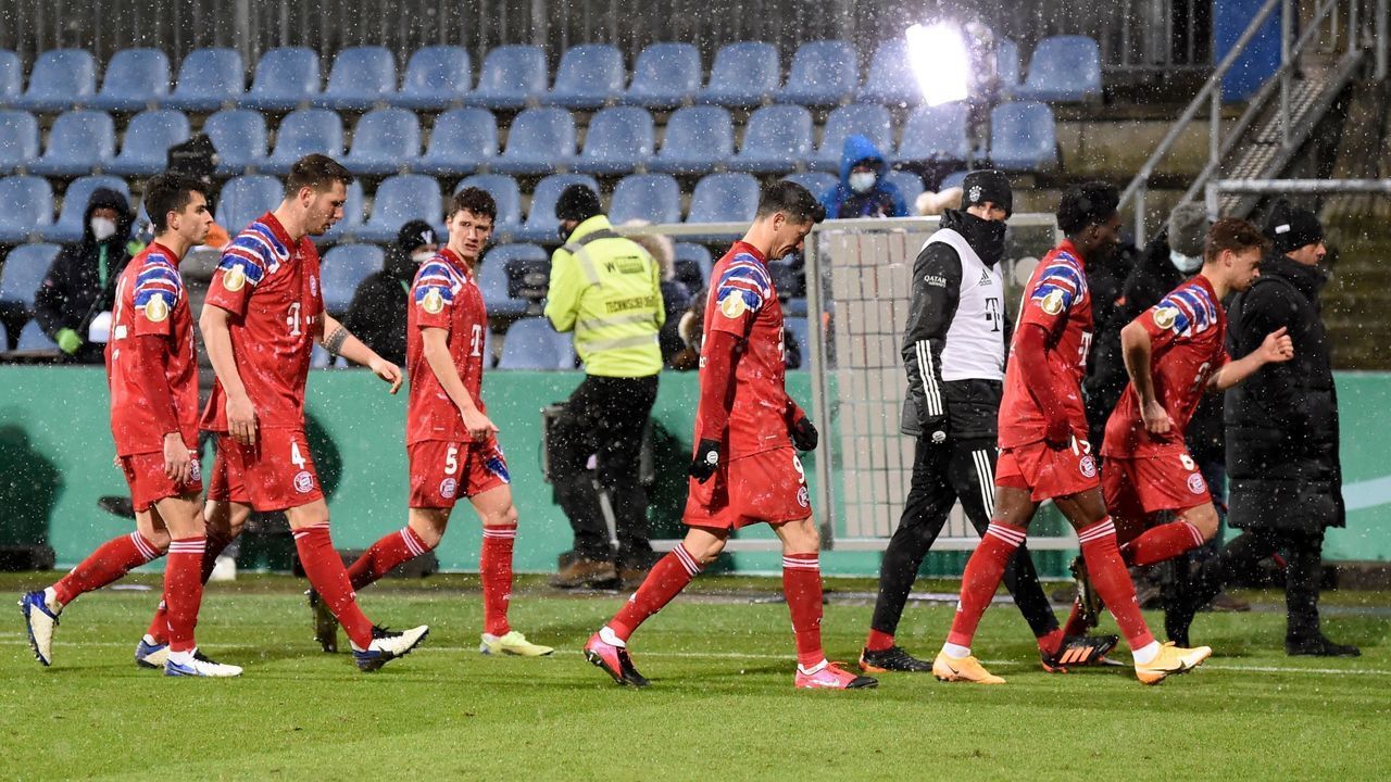 Bayern Munich's players leave the pitch after losing in a penalty shootout following extra time during the German Cup (DFB Pokal) second round football match between Holstein Kiel and FC Bayern Munich in Kiel, northern Germany, on January 13, 2021. - Second division football club Kiel knocked Bayern Munich out of German Cup on penalties.