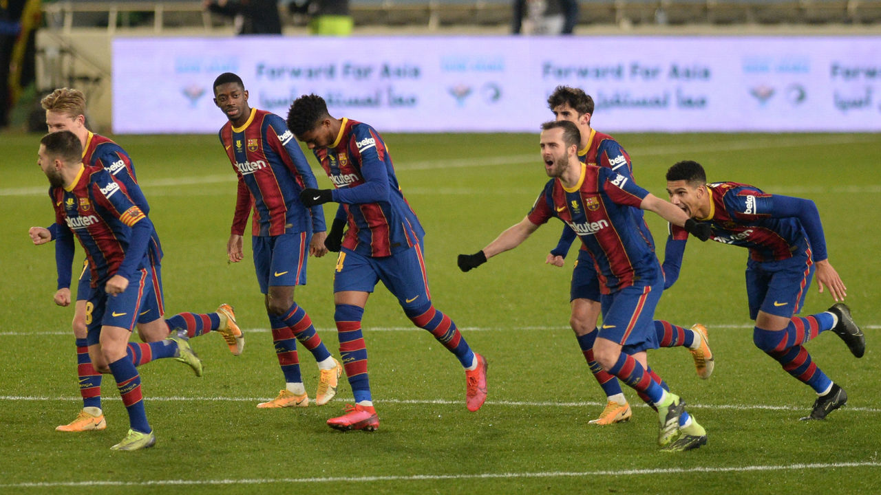 Barcelona players celebrate their victory after the penalty shoot-out in Spanish Super Cup semi final football match between Real Sociedad and FC Barcelona at the Nuevo Arcangel stadium in Cordoba on January 13, 2021.