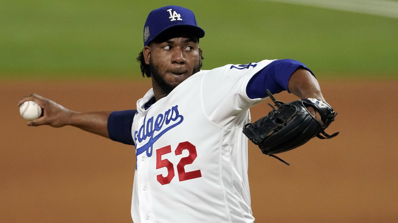ARLINGTON, TX - OCTOBER 27: Pedro Baez #52 of the Los Angeles Dodgers pitches during Game 6 of the 2020 World Series between the Los Angeles Dodgers and the Tampa Bay Rays at Globe Life Field on Tuesday, October 27, 2020 in Arlington, Texas.