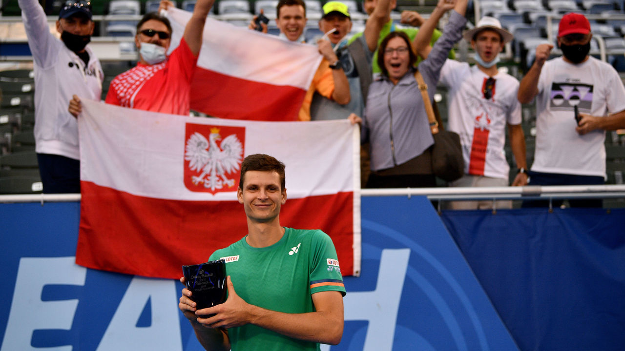 DELRAY BEACH, FLORIDA - JANUARY 13: Hubert Hurkacz of Poland poses with the Delray Open Trophy in front of Polish fans after winning against Sebastian Korda in the Finals of the Delray Beach Open by Vitacost.com at Delray Beach Tennis Center on January 13, 2021 in Delray Beach, Florida.