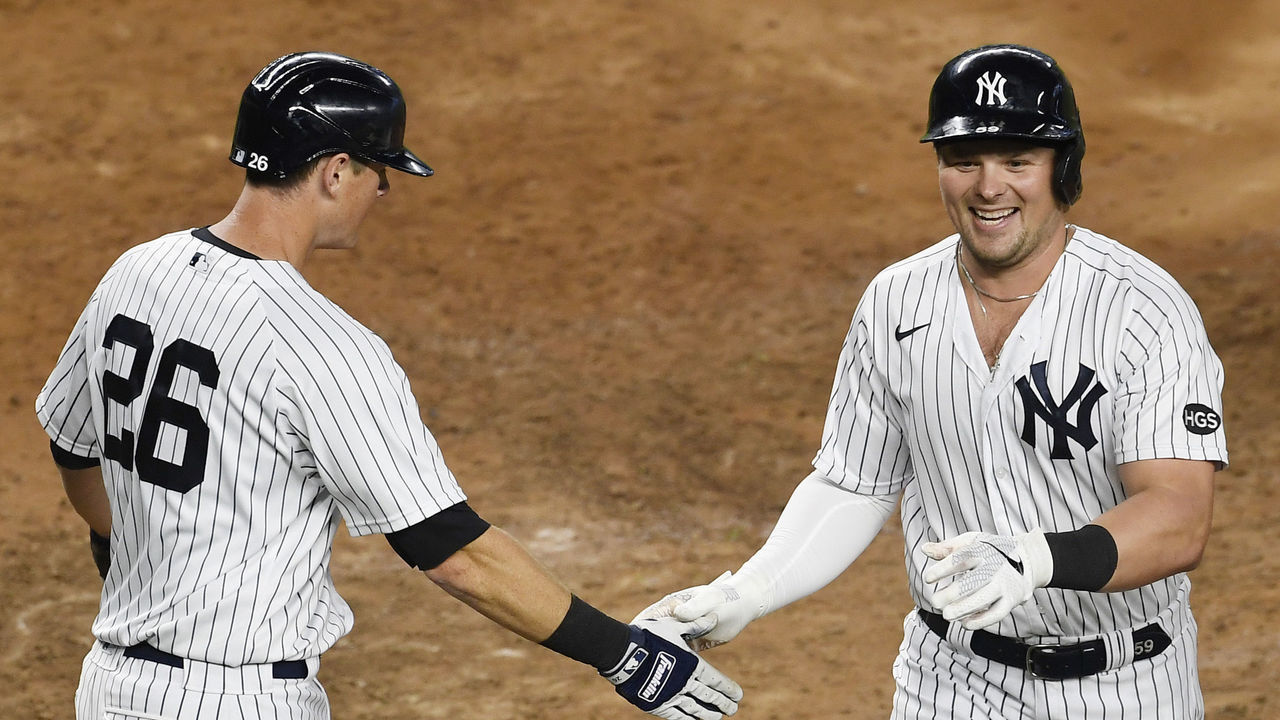 NEW YORK, NEW YORK - SEPTEMBER 16: Luke Voit #59 reacts with DJ LeMahieu #26 of the New York Yankees after hitting a home run during the sixth inning against the Toronto Blue Jays at Yankee Stadium on September 16, 2020 in the Bronx borough of New York City.