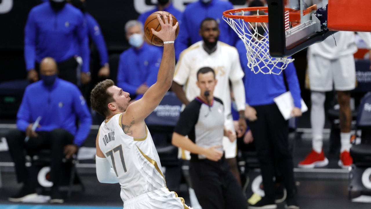CHARLOTTE, NORTH CAROLINA - JANUARY 13: Luka Doncic #77 of the Dallas Mavericks attempts a lay up during the third quarter of their game against the Charlotte Hornets at Spectrum Center on January 13, 2021 in Charlotte, North Carolina.