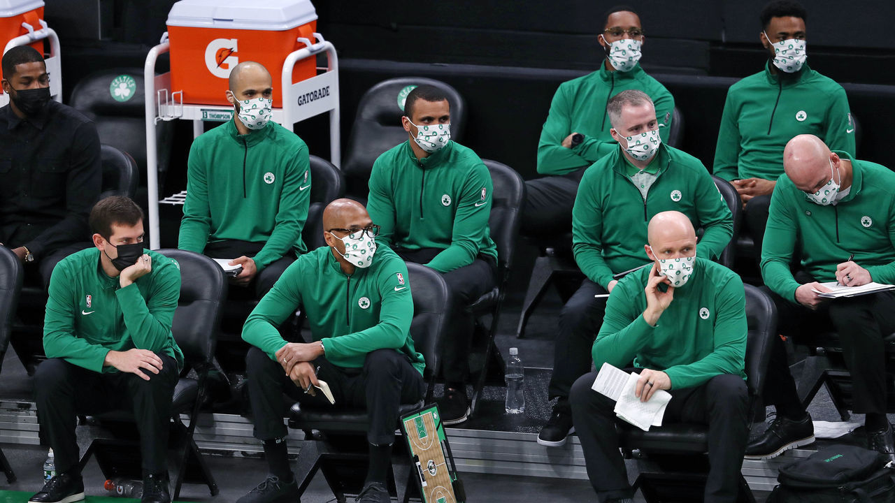 BOSTON, MA - DECEMBER 30: Boston Celtics Head Coach Brad Stevens, (bottom left), has plenty of company as his large group of masked assistant coaches, (and a few others), fill the seats at the home bench area. The Boston Celtics hosted the Memphis Grizzlies in a regular season NBA basketball game December 30, 2020 at TD Garden.