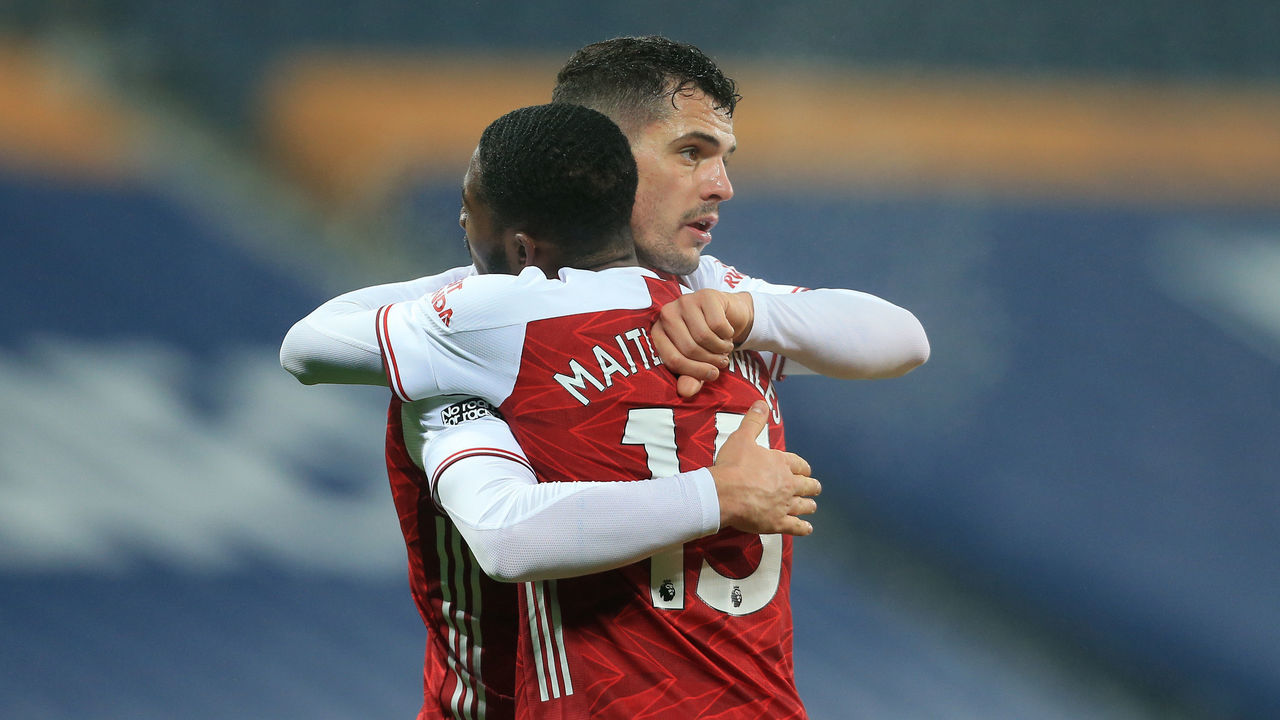 WEST BROMWICH, ENGLAND - JANUARY 02: Granit Xhaka of Arsenal and Ainsley Maitland-Niles of Arsenal hug following their victory during the Premier League match between West Bromwich Albion and Arsenal at The Hawthorns on January 2, 2021 in West Bromwich, United Kingdom. The match will be played without fans, behind closed doors as a Covid-19 precaution.