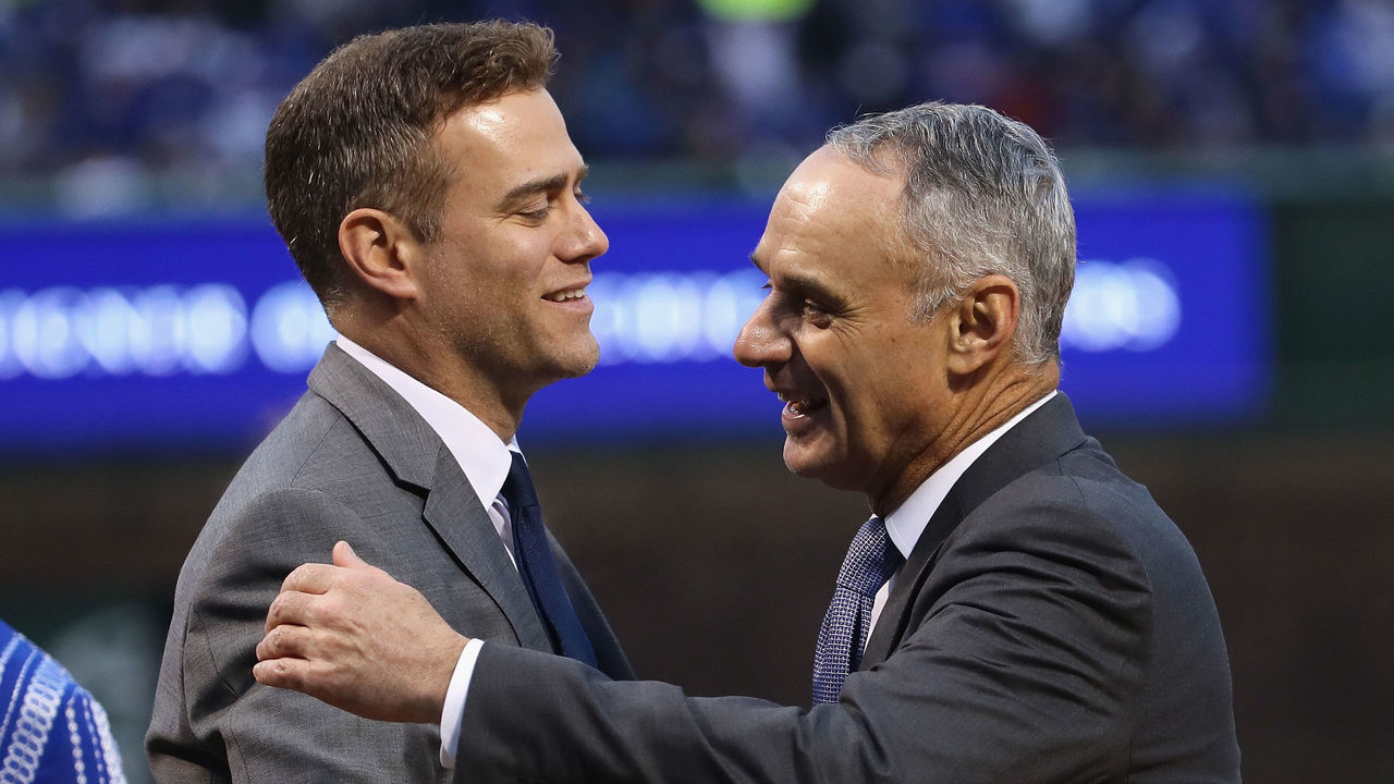 CHICAGO, IL - APRIL 12: President Theo Epstein of the Chicago Cubs is congratulated by Rob Manfred, comissioner of Major League baseball, during a ring ceremony before a game against the Los Angeles Dodgers at Wrigley Field on April 12, 2017 in Chicago, Illinois.