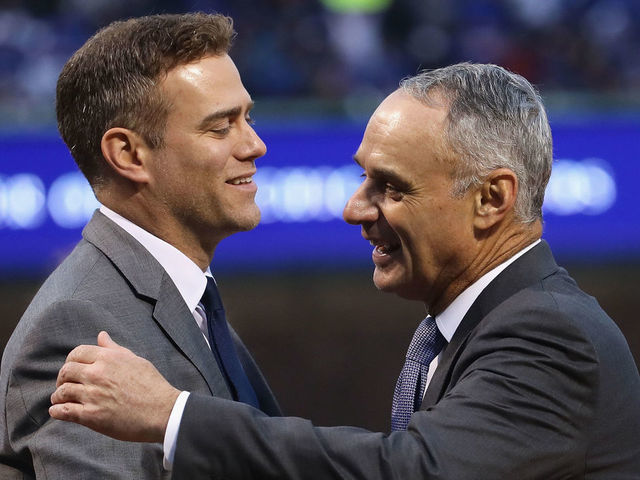 CHICAGO, IL - APRIL 12: President Theo Epstein of the Chicago Cubs is congratulated by Rob Manfred, comissioner of Major League baseball, during a ring ceremony before a game against the Los Angeles Dodgers at Wrigley Field on April 12, 2017 in Chicago, Illinois.