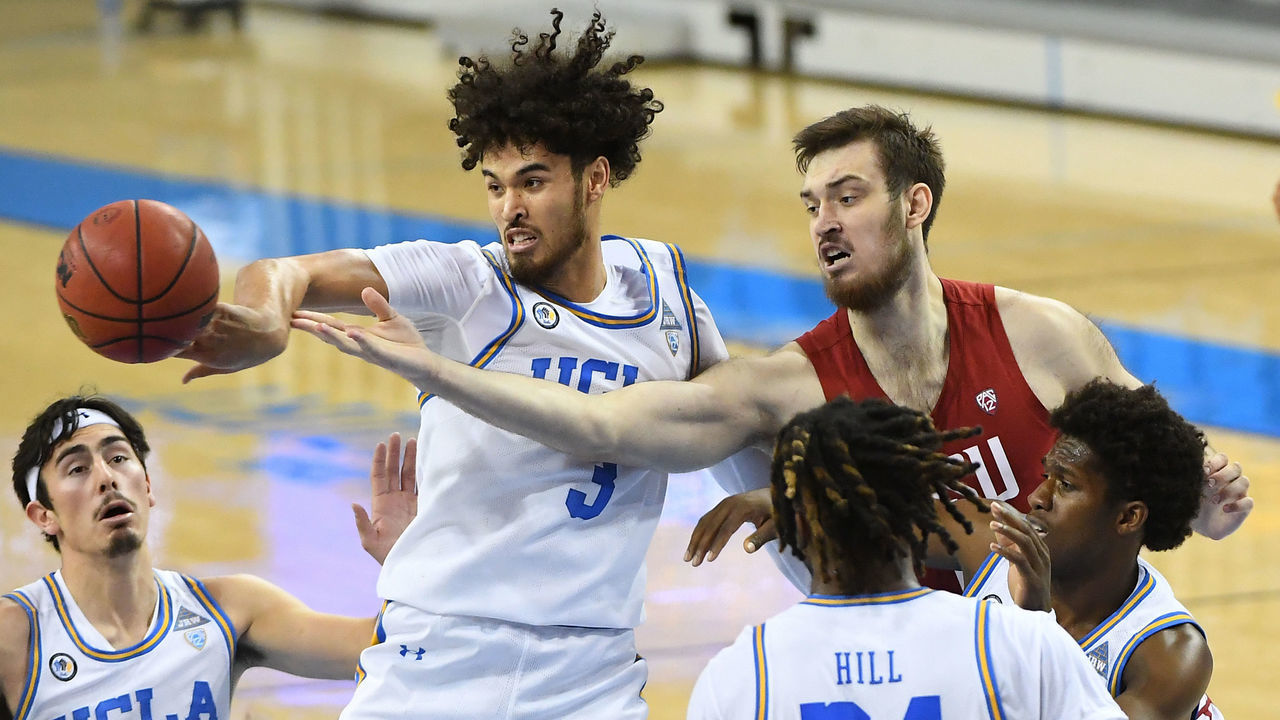 LOS ANGELES, CA - JANUARY 14: Johnny Juzang #3 of the UCLA Bruins knocks a rebound away from Volodymyr Markovetskyy #15 of the Washington State Cougars in the second half at Pauley Pavilion on January 14, 2021 in Los Angeles, California.