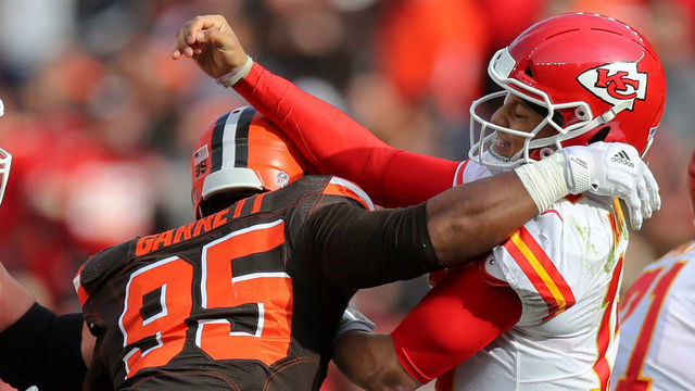 CLEVELAND, OH - NOVEMBER 04: Kansas City Chiefs quarterback Patrick Mahomes (15) is hit by Cleveland Browns defensive end Myles Garrett (95) after throwing a pass during the second quarter of the National Football League game between the Kansas City Chiefs and Cleveland Browns on November 4, 2018, at FirstEnergy Stadium in Cleveland, OH.