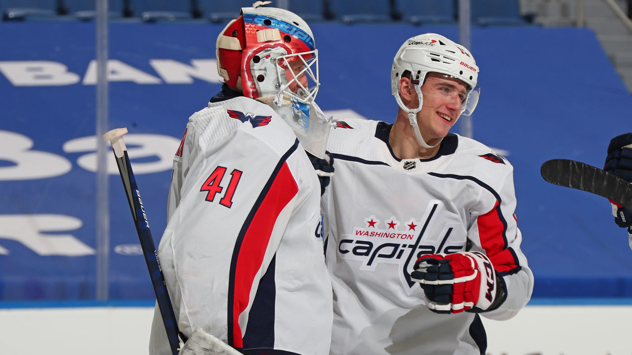 BUFFALO, NY - JANUARY 15: Jakub Vrana #13 celebrates with Vitek Vanecek #41 of the Washington Capitals after an NHL game against the Buffalo Sabres on January 15, 2021 at KeyBank Center in Buffalo, New York. Washington won, 2-1.
