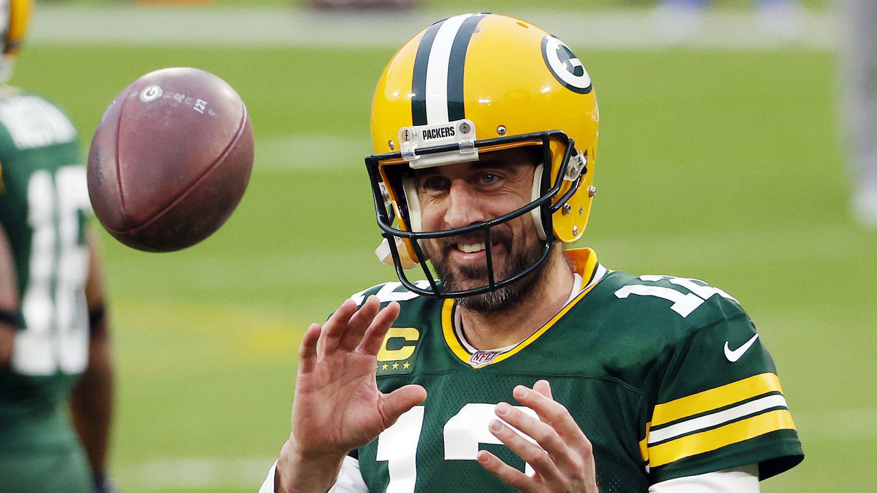 GREEN BAY, WISCONSIN - JANUARY 16: Aaron Rodgers #12 of the Green Bay Packers warms up before the NFC Divisional Playoff game against the Los Angeles Rams at Lambeau Field on January 16, 2021 in Green Bay, Wisconsin.