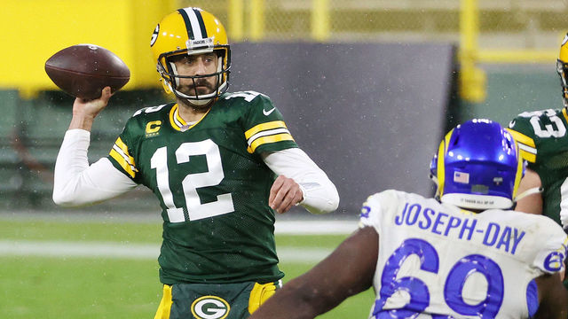 GREEN BAY, WISCONSIN - JANUARY 16: Aaron Rodgers #12 of the Green Bay Packers throws a pass in the first half against the Los Angeles Rams during the NFC Divisional Playoff game at Lambeau Field on January 16, 2021 in Green Bay, Wisconsin.