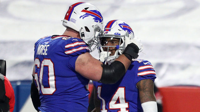 ORCHARD PARK, NEW YORK - JANUARY 16: Stefon Diggs #14 of the Buffalo Bills celebrates after catching a touchdown in the third quarter with Mitch Morse #60 against the Baltimore Ravens during the AFC Divisional Playoff game at Bills Stadium on January 16, 2021 in Orchard Park, New York.