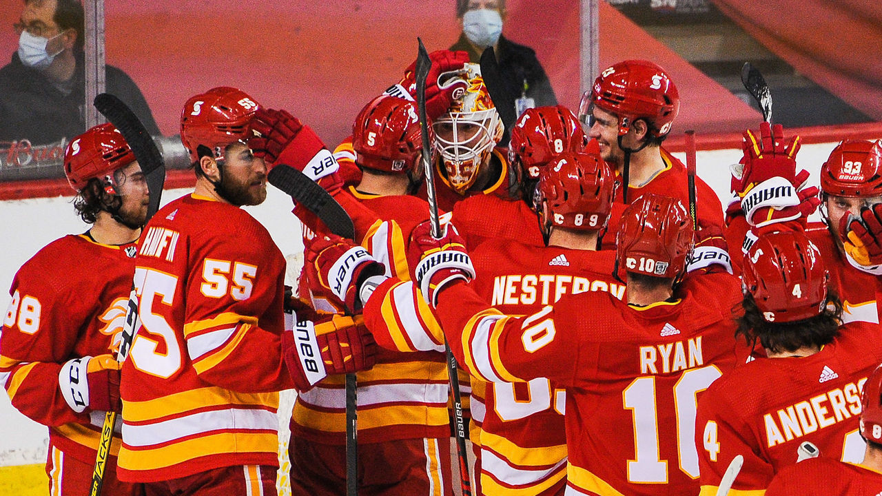 CALGARY, AB - JANUARY 16: The Calgary Flames celebrate after winning in their first home game at Scotiabank Saddledome on January 16, 2021 in Calgary, Alberta, Canada.