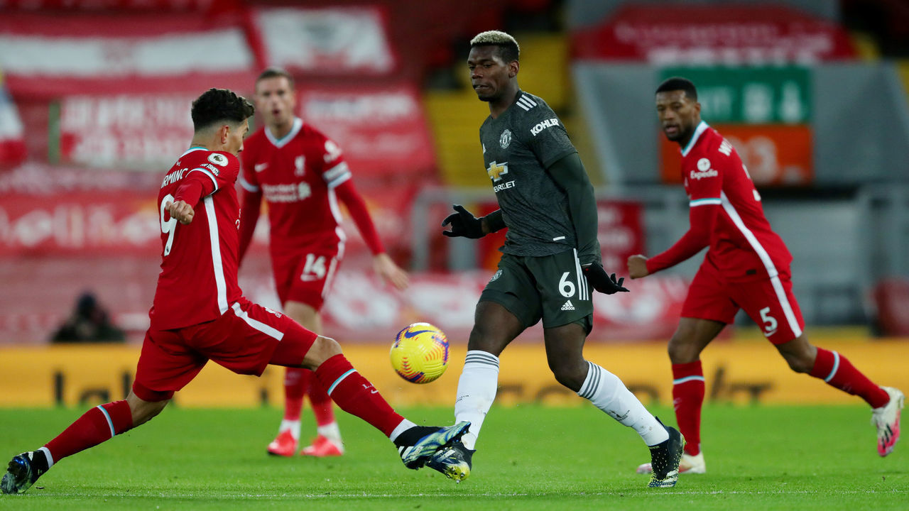 LIVERPOOL, ENGLAND - JANUARY 17: Manchester United's Paul Pogba and Liverpool's Roberto Firmino during the Premier League match between Liverpool and Manchester United at Anfield on January 17, 2021 in Liverpool, United Kingdom.