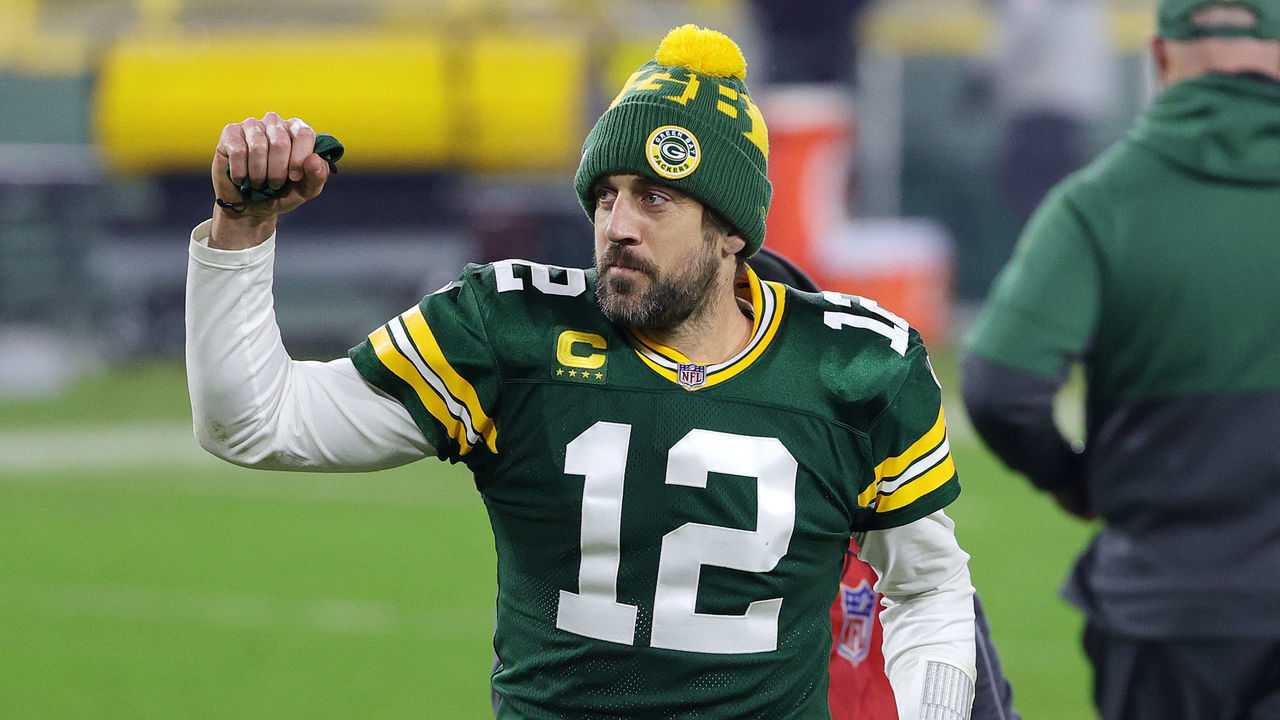 GREEN BAY, WISCONSIN - JANUARY 16: Aaron Rodgers #12 of the Green Bay Packers celebrates defeating the Los Angeles Rams 32-18 in the NFC Divisional Playoff game at Lambeau Field on January 16, 2021 in Green Bay, Wisconsin.