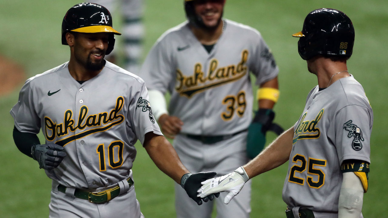 ARLINGTON, TEXAS - SEPTEMBER 12: Marcus Semien #10 of the Oakland Athletics celebrates a three-run homerun with Stephen Piscotty #25 against the Texas Rangers in the fifth inning at Globe Life Field on September 12, 2020 in Arlington, Texas.
