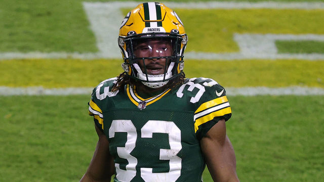 GREEN BAY, WISCONSIN - DECEMBER 19: Running back Aaron Jones #33 of the Green Bay Packers celebrates after scoring a touchdown in the second quarter of the game against the Carolina Panthers at Lambeau Field on December 19, 2020 in Green Bay, Wisconsin.