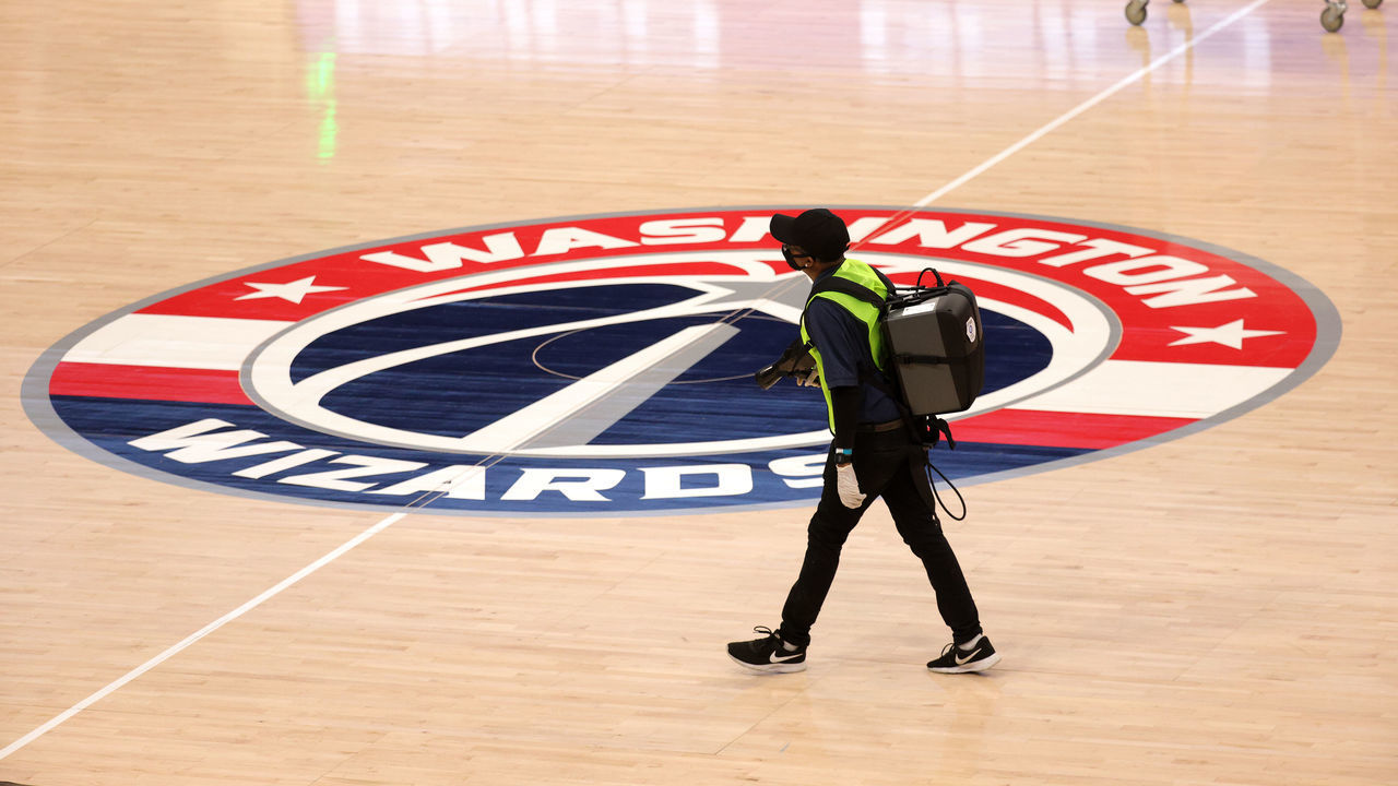 WASHINGTON, DC - DECEMBER 19: A worker walks on the court before disinfecting the baskets before the start of the Washington Wizards and Detroit Pistons preseason game at Capital One Arena on December 19, 2020 in Washington, DC.