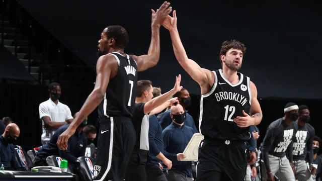 BROOKLYN, NY - JANUARY 18: Joe Harris #12 hi-fives Kevin Durant #7 of the Brooklyn Nets during the game against the Milwaukee Bucks on January 18, 2021 at Barclays Center in Brooklyn, New York. Mandatory Copyright Notice: Copyright 2021 NBAE