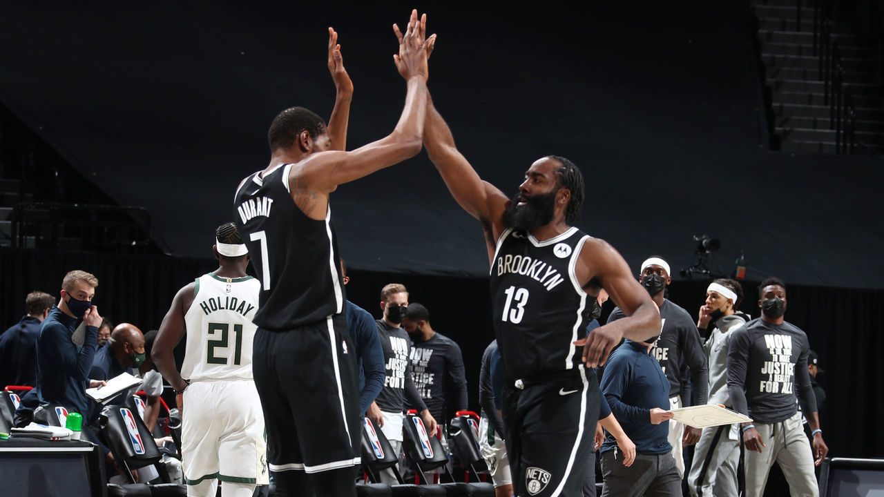 BROOKLYN, NY - JANUARY 18: James Harden #13 hi-fives Kevin Durant #7 of the Brooklyn Nets during the game against the Milwaukee Bucks on January 18, 2021 at Barclays Center in Brooklyn, New York. Mandatory Copyright Notice: Copyright 2021 NBAE