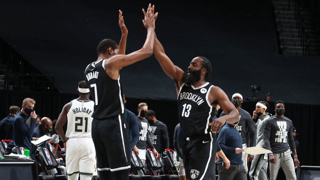 BROOKLYN, NY - JANUARY 18: James Harden #13 hi-fives Kevin Durant #7 of the Brooklyn Nets during the game against the Milwaukee Bucks on January 18, 2021 at Barclays Center in Brooklyn, New York. Mandatory Copyright Notice: Copyright 2021 NBAE