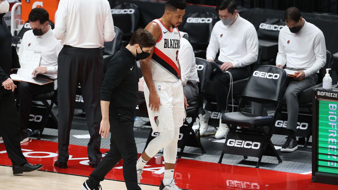 PORTLAND, OREGON - JANUARY 16: CJ McCollum #3 of the Portland Trail Blazers has a conversation with a team attendant in the second quarter against the Atlanta Hawks at Moda Center on January 16, 2021 in Portland, Oregon.