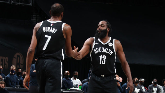 BROOKLYN, NY - JANUARY 18: James Harden #13 hi-fives Kevin Durant #7 of the Brooklyn Nets during the game against the Milwaukee Bucks on January 18, 2021 at Barclays Center in Brooklyn, New York. Mandatory Copyright Notice: Copyright 2021 NBAE