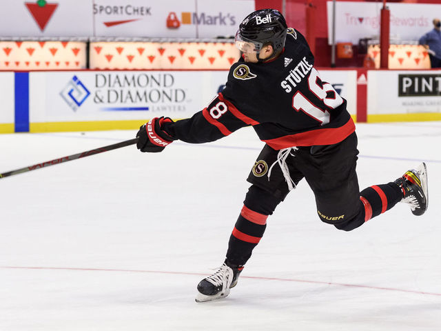 OTTAWA, ON - JANUARY 16: Ottawa Senators Left Wing Tim Stuetzle (18) shoots the puck during the pre-game warm up before the NHL game between the Ottawa Senators and the Toronto Maple Leafs on January 16, 2021 at the Canadian Tire Centre in Ottawa, Ontario, Canada.