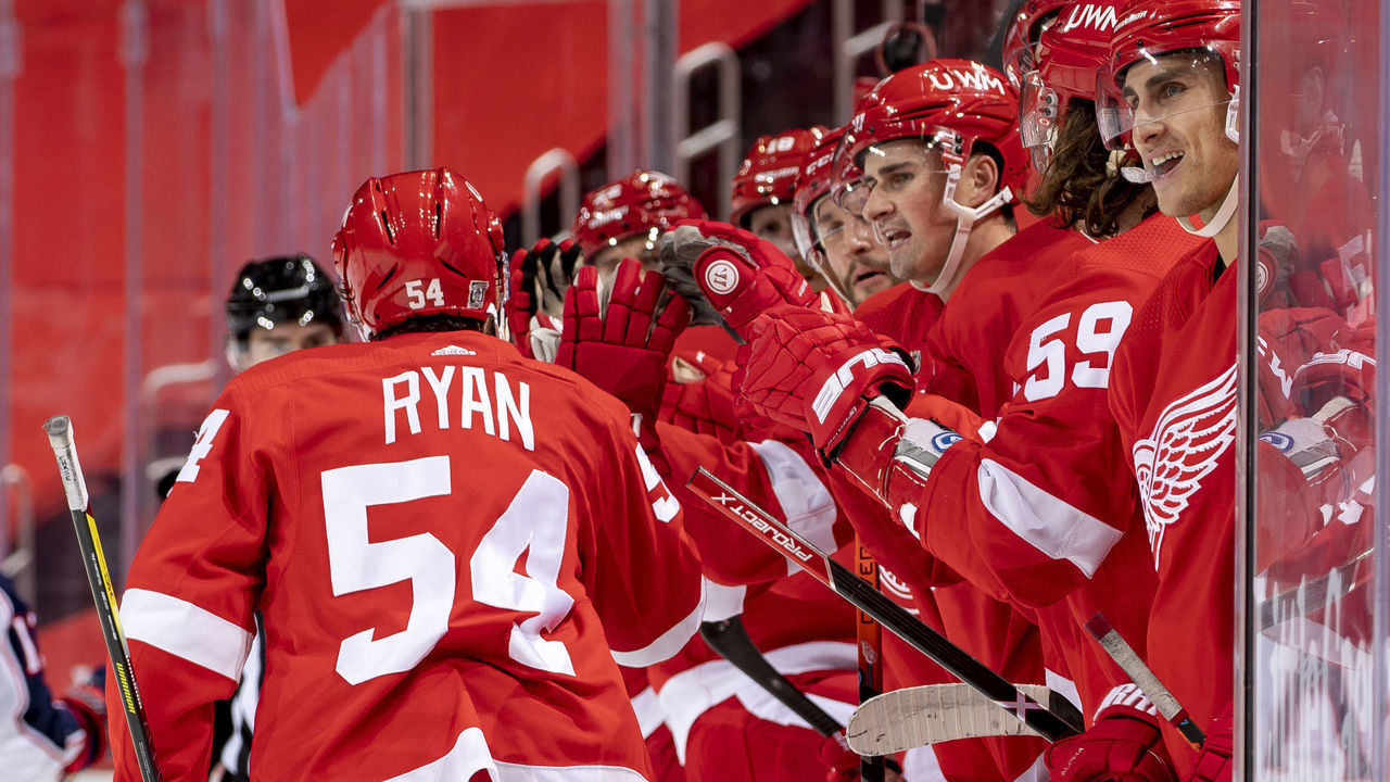 DETROIT, MI - JANUARY 19: Bobby Ryan #54 of the Detroit Red Wings taps gloves with teammates on the bench after scoring a goal during the second period of an NHL game against the Columbus Blue Jackets at Little Caesars Arena on January 19, 2021 in Detroit, Michigan.