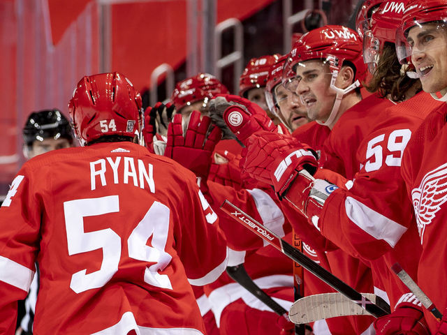 DETROIT, MI - JANUARY 19: Bobby Ryan #54 of the Detroit Red Wings taps gloves with teammates on the bench after scoring a goal during the second period of an NHL game against the Columbus Blue Jackets at Little Caesars Arena on January 19, 2021 in Detroit, Michigan.
