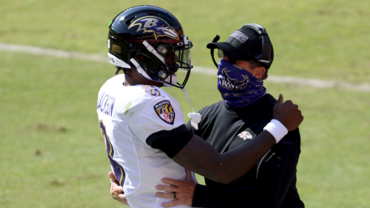 LANDOVER, MARYLAND - OCTOBER 04: Quarterback Lamar Jackson #8 of the Baltimore Ravens celebrates with head coach John Harbaugh after rushing for a second quarter touchdown against the Washington Football Team at FedExField on October 04, 2020 in Landover, Maryland.