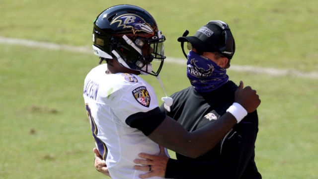 LANDOVER, MARYLAND - OCTOBER 04: Quarterback Lamar Jackson #8 of the Baltimore Ravens celebrates with head coach John Harbaugh after rushing for a second quarter touchdown against the Washington Football Team at FedExField on October 04, 2020 in Landover, Maryland.