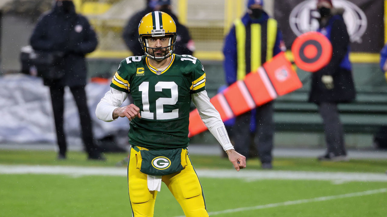 GREEN BAY, WISCONSIN - JANUARY 16: Aaron Rodgers #12 of the Green Bay Packers celebrates after scoring a touchdown in the second quarter against the Los Angeles Rams during the NFC Divisional Playoff game at Lambeau Field on January 16, 2021 in Green Bay, Wisconsin.
