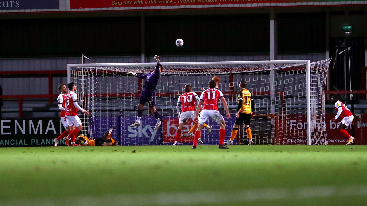 CHELTENHAM, ENGLAND - JANUARY 19: Tom King of Newport County makes a save during the Sky Bet League Two match between Cheltenham Town and Newport County at The Jonny-Rocks Stadium on January 19, 2021 in Cheltenham, England. Sporting stadiums around the UK remain under strict restrictions due to the Coronavirus Pandemic as Government social distancing laws prohibit fans inside venues resulting in games being played behind closed doors.