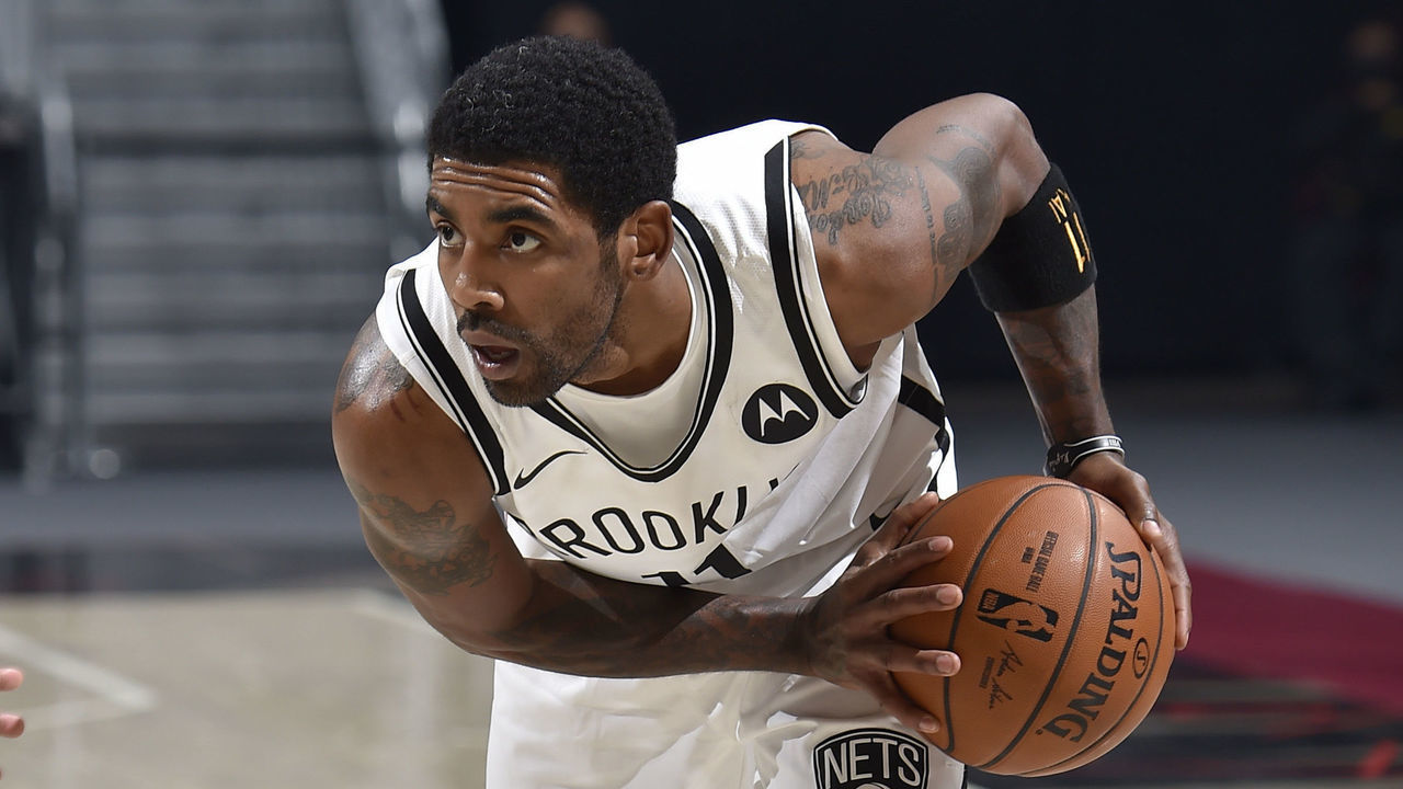 CLEVELAND, OH - JANUARY 20: Kyrie Irving #11 of the Brooklyn Nets handles the ball during the game against the Cleveland Cavaliers on January 20, 2021 at Rocket Mortgage FieldHouse in Cleveland, Ohio. NOTE TO USER: User expressly acknowledges and agrees that, by downloading and/or using this Photograph, user is consenting to the terms and conditions of the Getty Images License Agreement. Mandatory Copyright Notice: Copyright 2021 NBAE