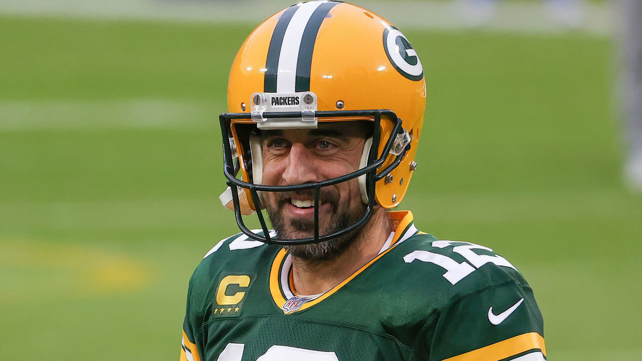 GREEN BAY, WISCONSIN - JANUARY 16: Aaron Rodgers #12 of the Green Bay Packers warms up before the game against the Los Angeles Rams during the NFC Divisional Playoff game at Lambeau Field on January 16, 2021 in Green Bay, Wisconsin.