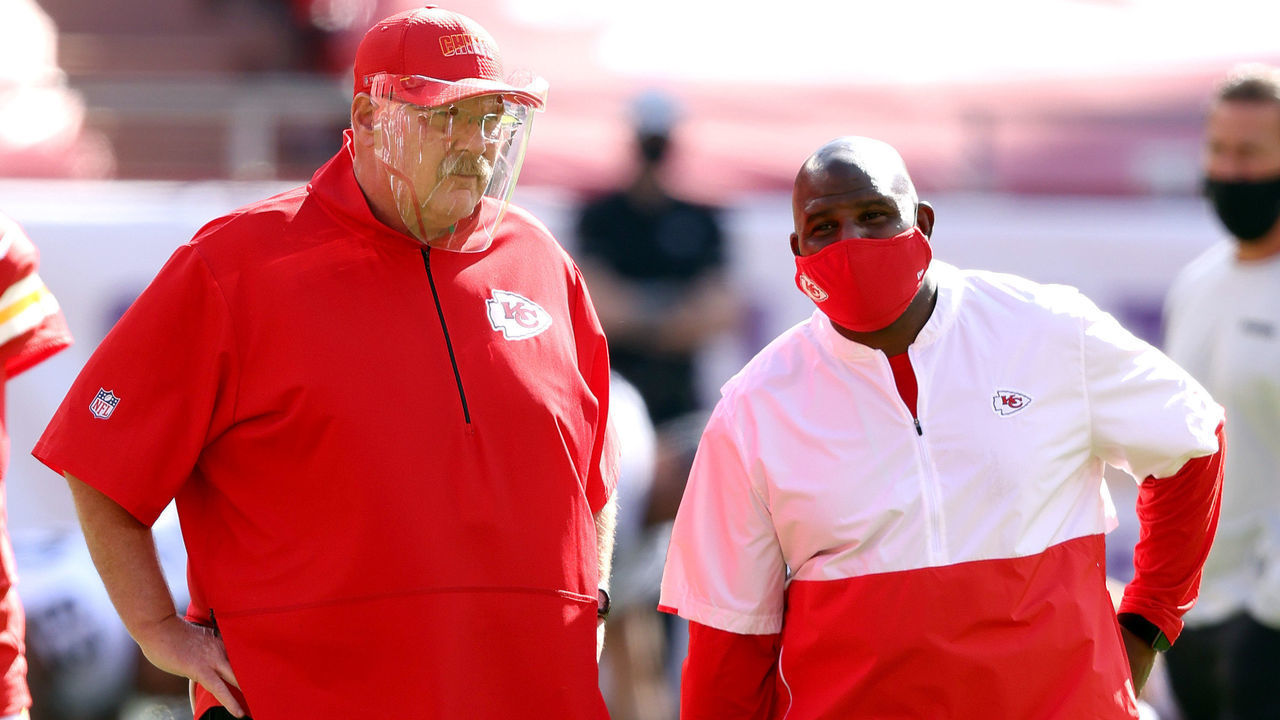 KANSAS CITY, MISSOURI - OCTOBER 11: Head coach Andy Reid of the Kansas City Chiefs speaks with offensive coordinator Eric Bieniemy prior to the game against the Las Vegas Raiders at Arrowhead Stadium on October 11, 2020 in Kansas City, Missouri.