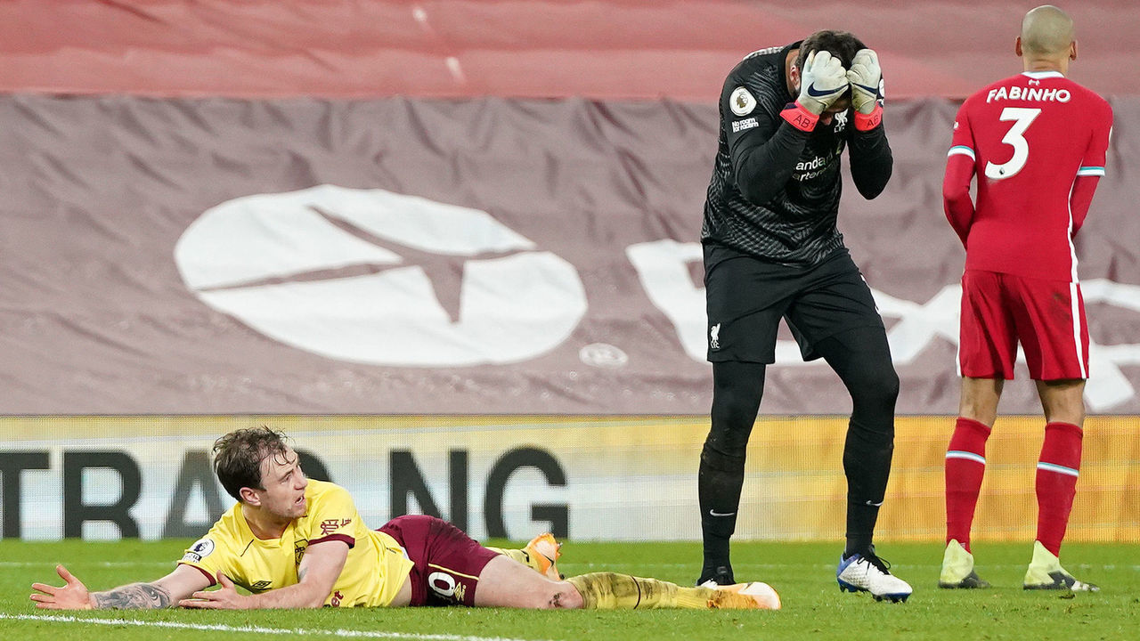 LIVERPOOL, ENGLAND - JANUARY 21: Alisson Becker of Liverpool reacts after fouling Ashley Barnes of Burnley leading to a penalty being awarded during the Premier League match between Liverpool and Burnley at Anfield on January 21, 2021 in Liverpool, England. Sporting stadiums around the UK remain under strict restrictions due to the Coronavirus Pandemic as Government social distancing laws prohibit fans inside venues resulting in games being played behind closed doors.